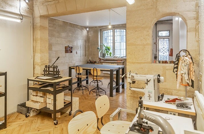 The interior of Atelier La Patine in Paris with leatherworking equipment and materials.